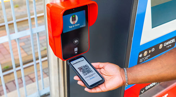 QR code being scanned on a fare validator on a METRORail platform.